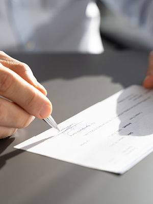 A person signing a business check