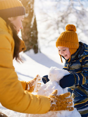 woman and child playing in the snow