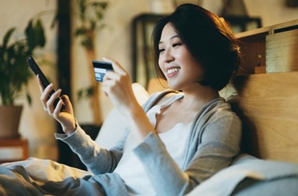 woman looking at her credit card