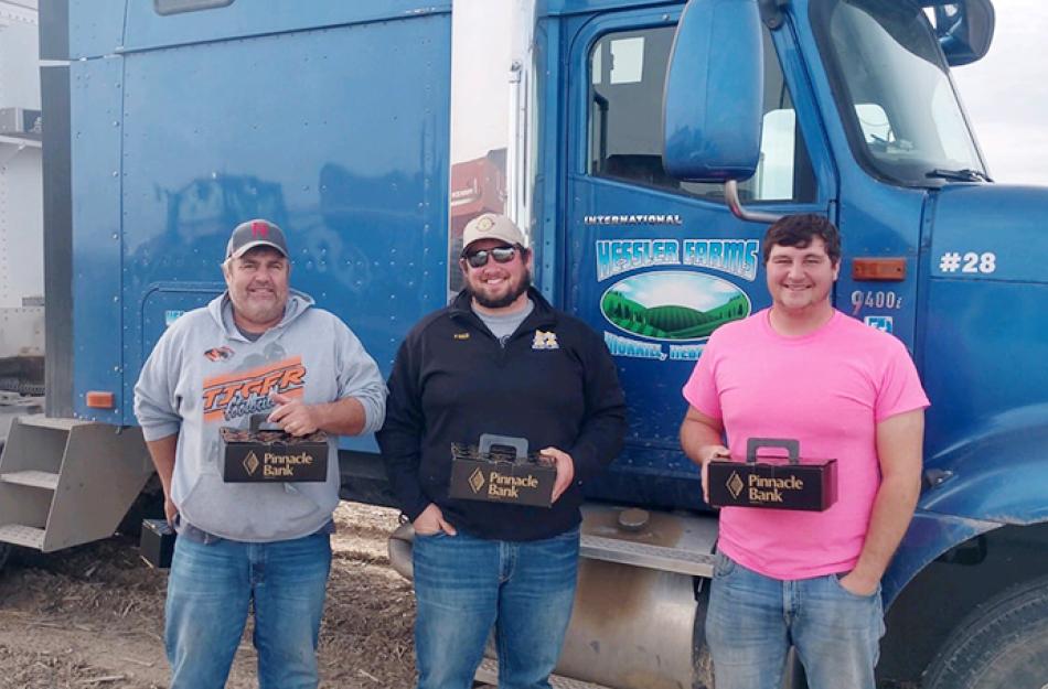 picture of 3 men in front of a truck