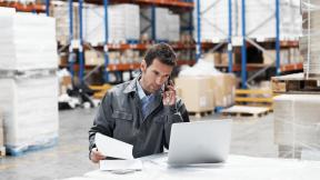 Man looking at a statement while working